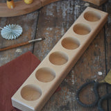 Wooden holder for 6 50ml glass jars. 