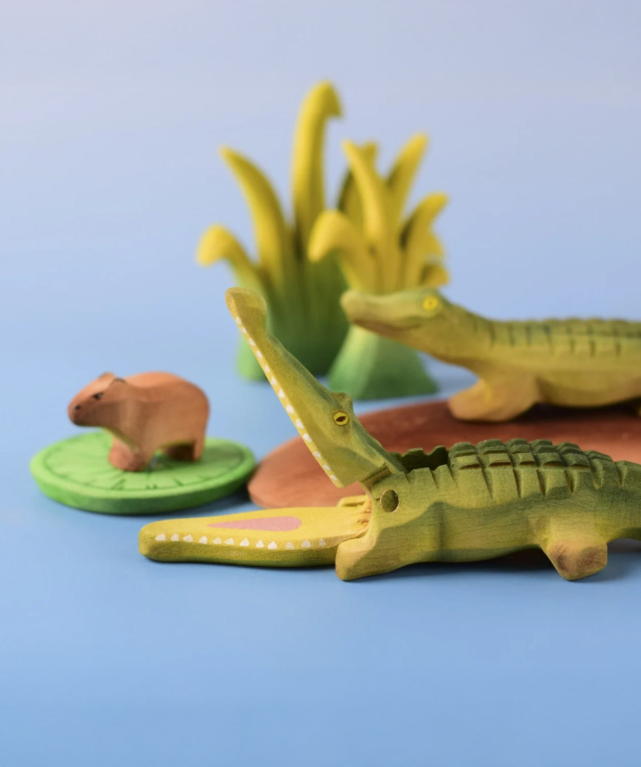 Bumbu Toys' Wooden Crocodile and Baby Crocodile, in a scene with Bumbu's Capybara, Reeds in large and small, and a Lilypad.