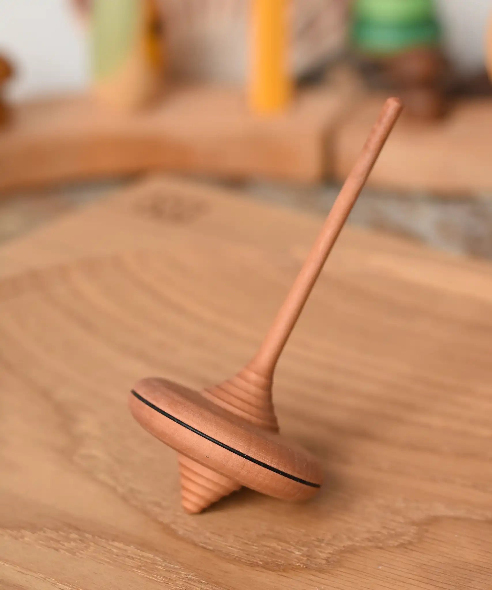 Mader ibis spinning top placed on a an oak spinning plate in the Babipur playroom.