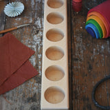 Wooden holder for 6 50ml glass jars. 