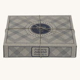 The cardboard giftbox that the Wooden Story baby duck rattle comes in. The box has a string tied around it. 