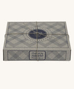 The cardboard giftbox that the Wooden Story baby duck rattle comes in. The box has a string tied around it. 