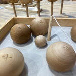 A selection of the balls from the Wooden Story boules set in a wooden box. 