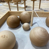 A selection of the balls from the Wooden Story boules set in a wooden box. 