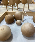 A selection of the balls from the Wooden Story boules set in a wooden box. 