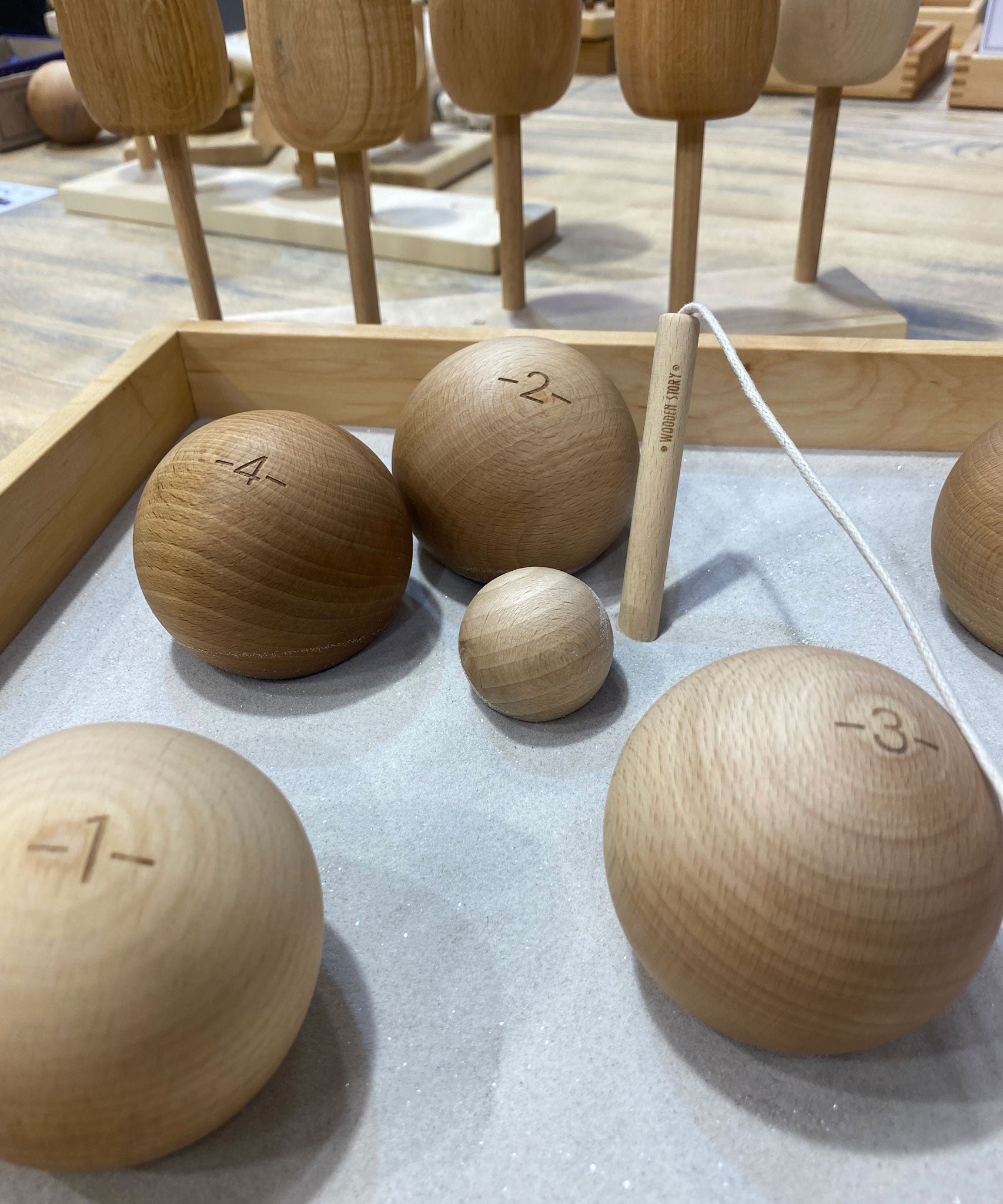 A selection of the balls from the Wooden Story boules set in a wooden box. 