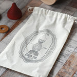 The cotton drawstring storage bag from the Wooden Story Stacking Toy Stick Purple Number 6 Figure.