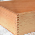 A close up of the corner of the Wooden Story play tray showing the finger joints.