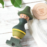 Wooden Story Stacking Toy Stick Figure - No7, a green stacking wooden figure wearing a hat. 