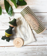 Wooden Story Stacking Toy Stick Figure - No7, a green stacking wooden figure wearing a hat. 