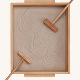 Wooden Story Montessori Sand Tray and Accessories shown on a plain background. The sand is in the tray with the tools. 
