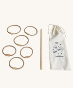 Wooden Story Traditional Style Wooden Loop Toss Game laid out on a plain background. The set includes 5 natural rope hoops with wooden connectors with a wooden stick and a cotton drawstring storage bag.  