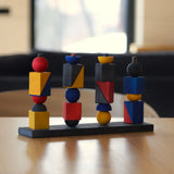 Wooden Story modern stacking toy on a table showing each Bauhaus inspired block stacked on the base