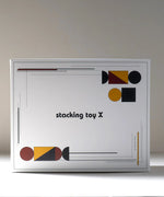 Packaging for the Wooden Story modern stacking toy showing Bauhaus inspired shapes on each corner