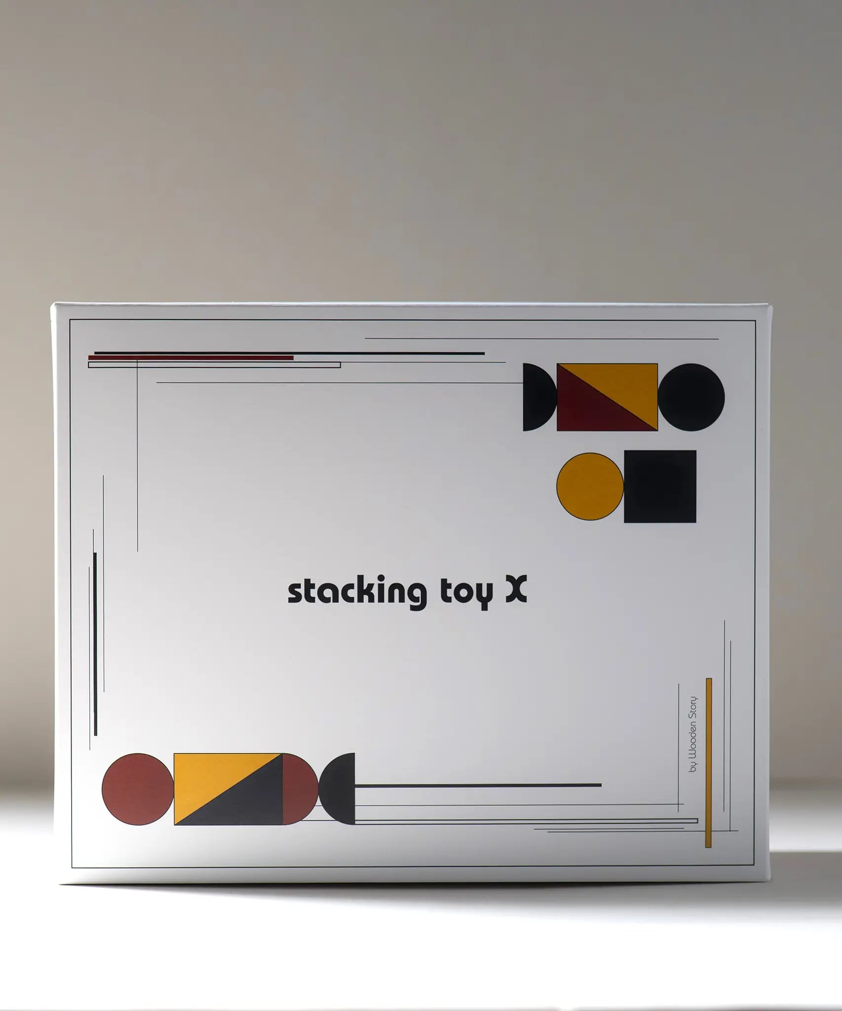 Packaging for the Wooden Story modern stacking toy showing Bauhaus inspired shapes on each corner
