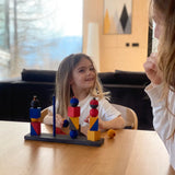 Child playing with the Bauhaus inspired blocks from the Wooden story modern stacking toy at the table