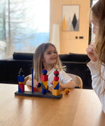 Child playing with the Bauhaus inspired blocks from the Wooden story modern stacking toy at the table