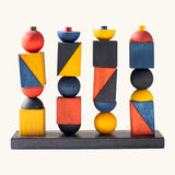 Wooden Story modern stacking toy. Includes a black base and Bauhaus inspired shaped blocks for stacking and creative play