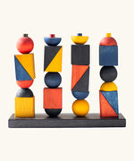 Wooden Story modern stacking toy. Includes a black base and Bauhaus inspired shaped blocks for stacking and creative play