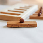 A close up of one of the rectangular shaped pieces that fit in the long short puzzle frame. The words Created by Wooden Story have been etched on the side. 