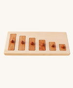 Wooden Story Montessori Long-Short wooden Knob Puzzle Toy. A wooden puzzle including a base frame and 5 rectangular shaped pieces in different lengths with round wooden knobs.  