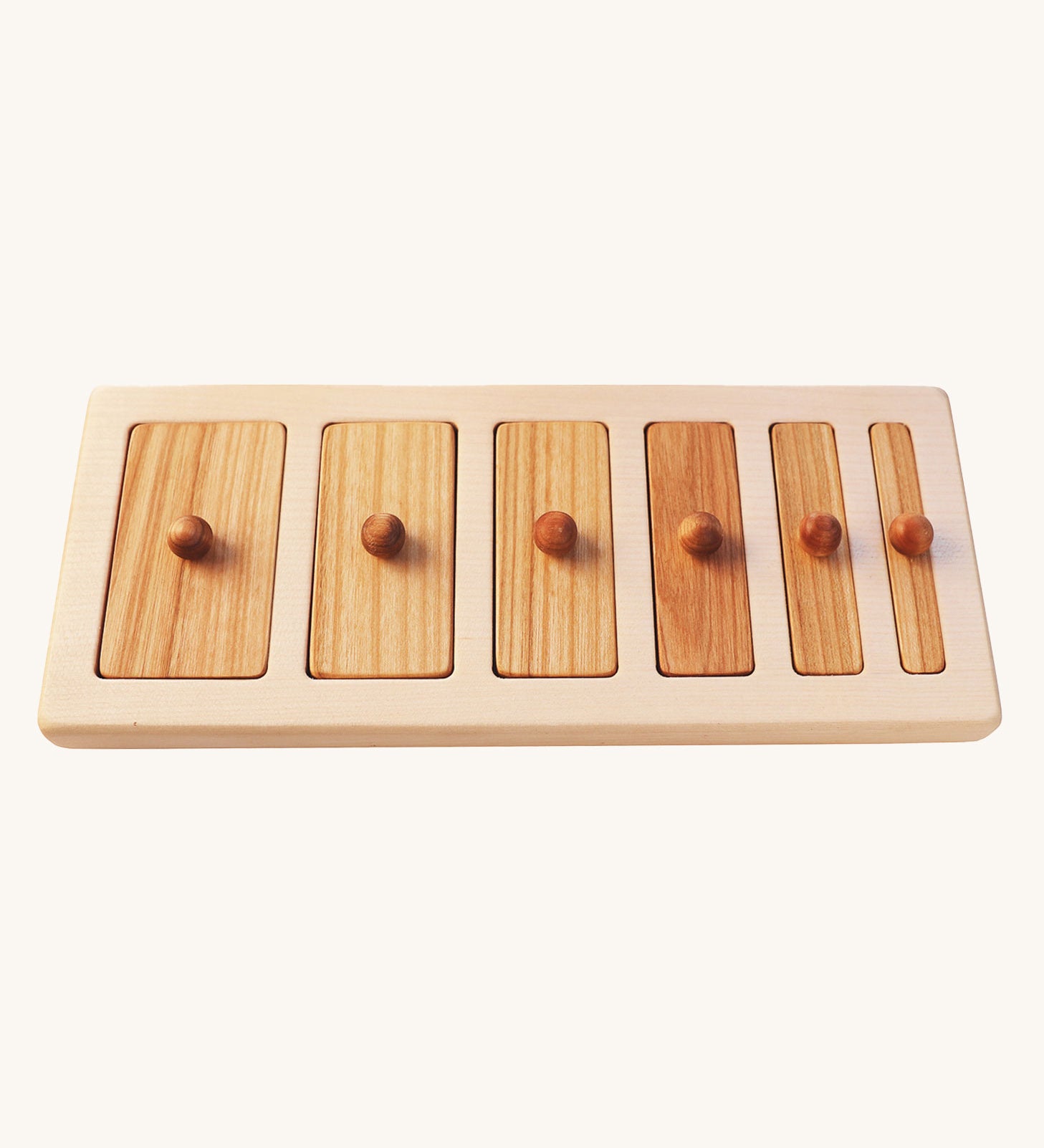 The Wooden Story Montessori Wide-Thin Knob Puzzle. A puzzle with 5 rectangular shaped pieces that fit into a wooden frame.