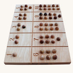 Wooden Story Number Tracking Board with wooden balls on a plain background. 