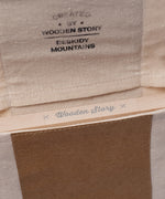A close up of the opening on the canvas pouch packaging that the Wooden Story Number Tracing Board comes in. 