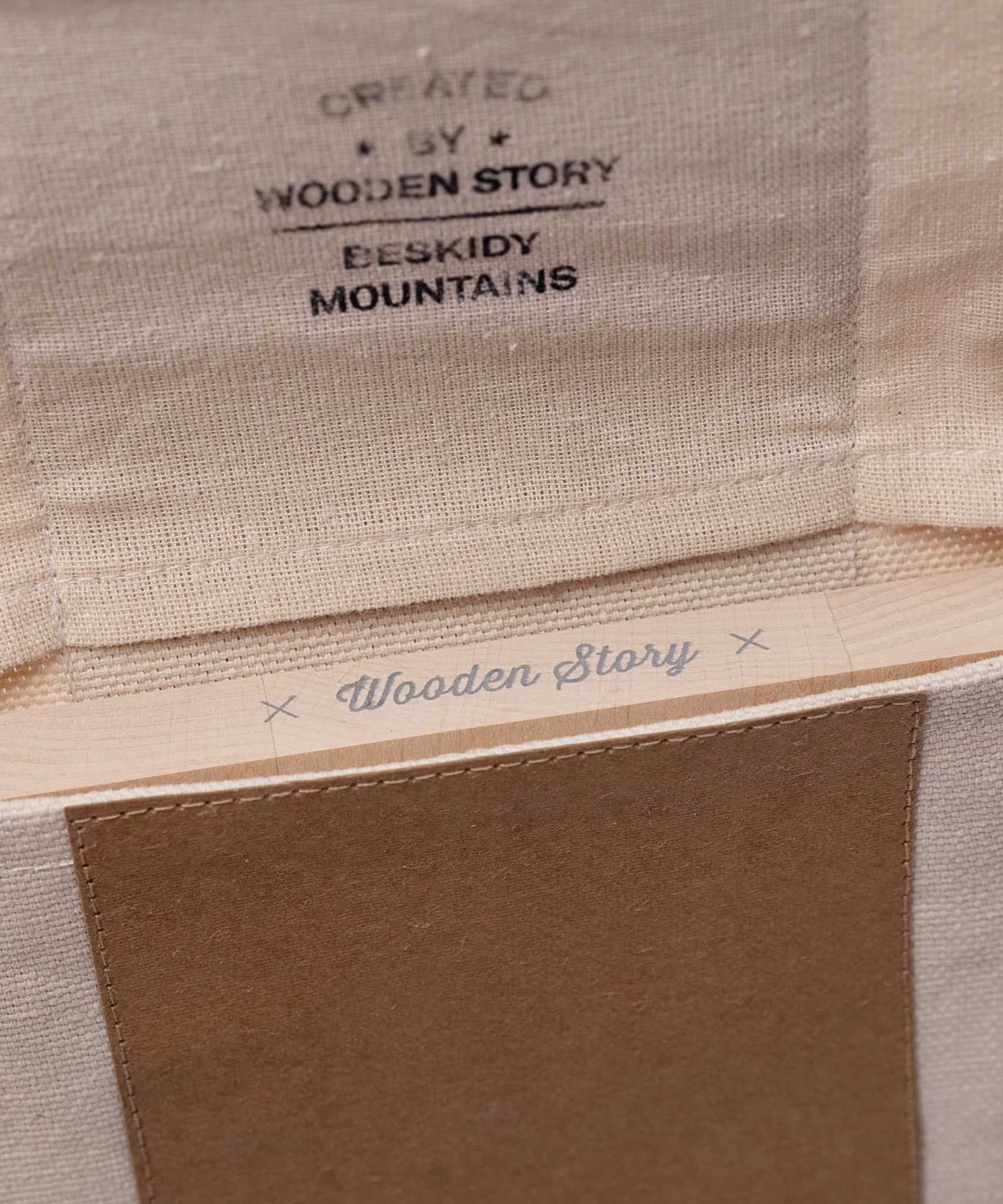 A close up of the opening on the canvas pouch packaging that the Wooden Story Number Tracing Board comes in. 
