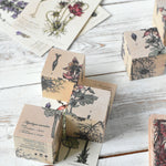 Three blocks from the Wooden Story Melliferous Plants Puzzle Block set placed on top of the matching card. 