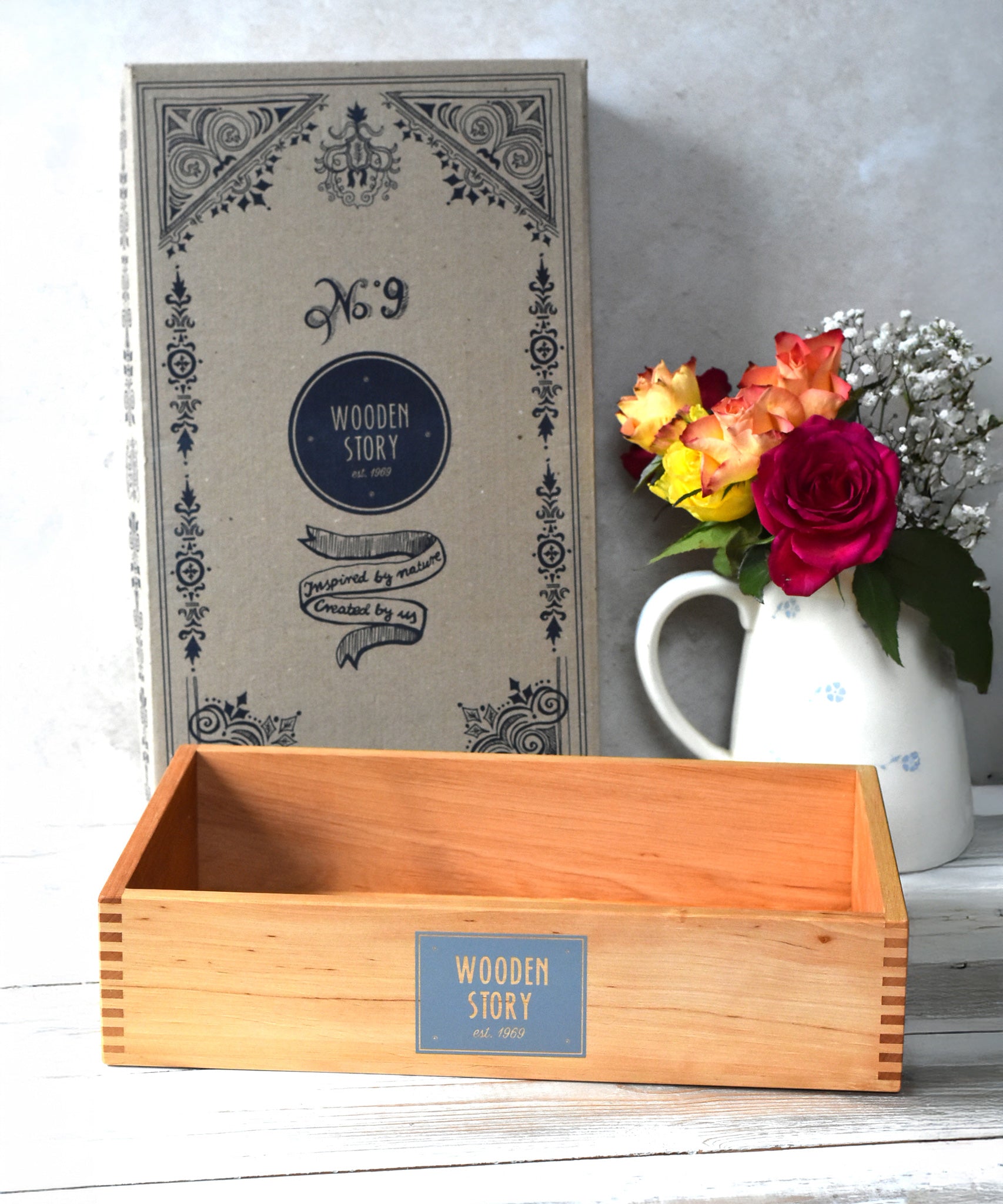 Wooden Story Montessori Sensory Play Tray placed in front of the cardboard gift packaging box.