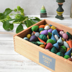 A Wooden Story Play Tray filled with Grapat mandala pieces.
