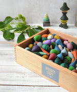 A Wooden Story Play Tray filled with Grapat mandala pieces.