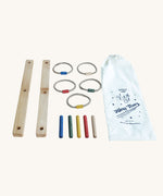 The pieces from the Wooden Story rainbow Ring Toss game laid out on a flat surface. The Traditional style Ring Toss game includes two batons of wood that make up the main frame 5 sticks that are placed in the frame, 5 rope hoops that have coloured connectors that match the hoop colours and a cotton drawstring storage bag