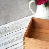 A close up of the corner of the Wooden Story play tray showing the finger joints and a look at the depth of the box.
