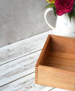 A close up of the corner of the Wooden Story play tray showing the finger joints and a look at the depth of the box.