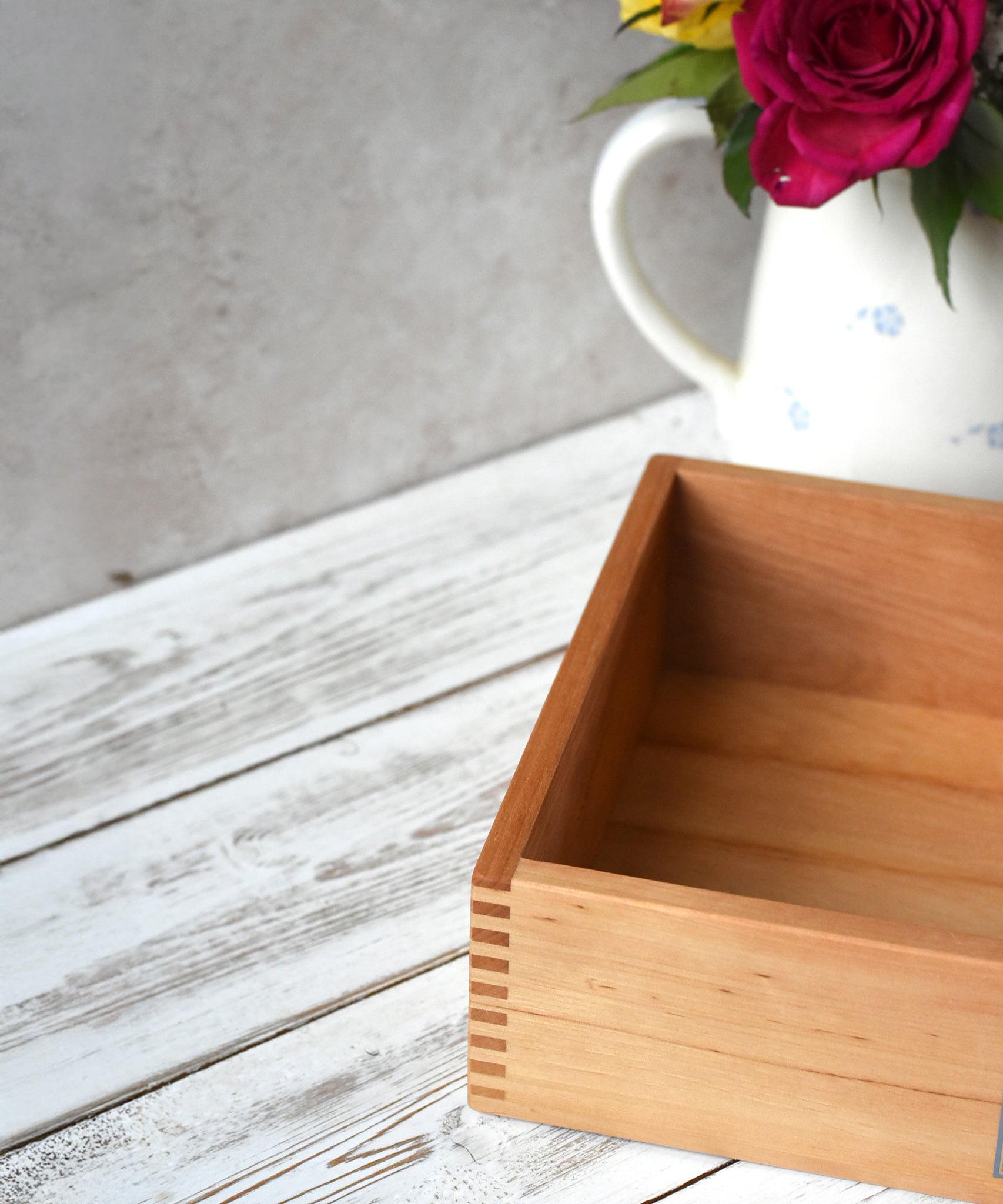 A close up of the corner of the Wooden Story play tray showing the finger joints and a look at the depth of the box.