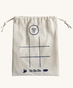 The drawstring bag that comes with the Wooden Story Tic Tac Toe set. A simple 9 space grid has been printed on the front of the bag.