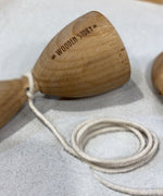 A close up of the etched Wooden Story logo on the cup of the Traditional Style Swing N' Catch cup and ball Game.