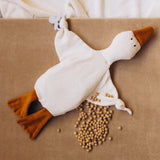 Wooly Organic goose heating pad available at Babipur. A organic cotton heating pad with cherry stones and  playful facial. Features ties on each arm to hold a pacifier. 
