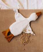 Wooly Organic goose heating pad available at Babipur. A organic cotton heating pad with cherry stones and  playful facial. Features ties on each arm to hold a pacifier. 