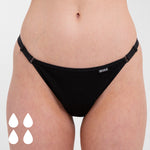 Close up of woman stood on a white background wearing the WUKA heavy flow flex logo detachable period pants