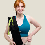 Woman with a Wuka wearable hot water bottle over her shoulder 