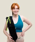 Woman with a Wuka wearable hot water bottle over her shoulder 