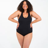 Front of woman wearing the Wuka perform period light/medium flow swimsuit in black