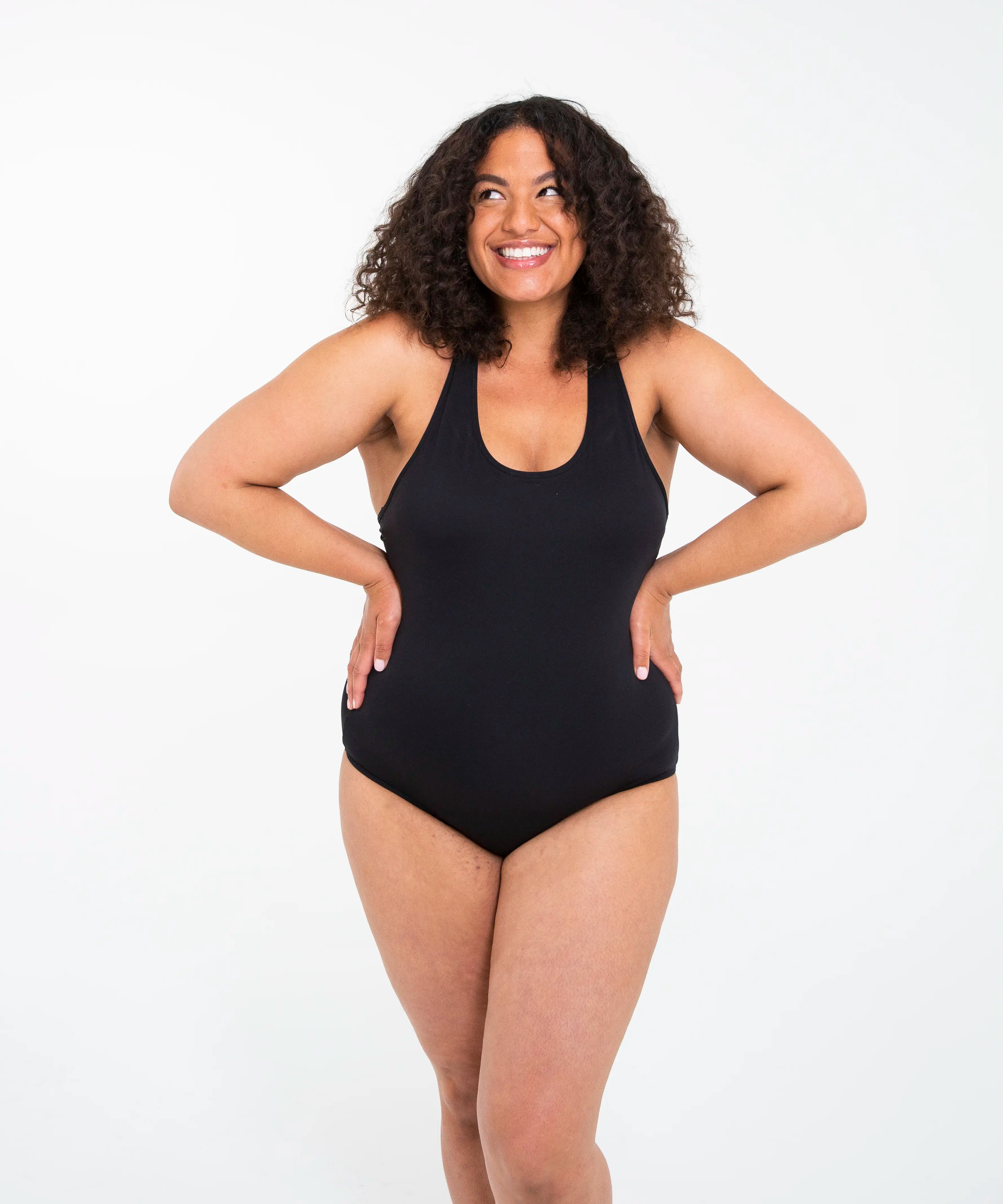 Front of woman wearing the Wuka perform period light/medium flow swimsuit in black