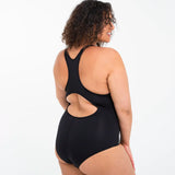 Side of woman wearing the Wuka perform period light/medium flow swimsuit in black