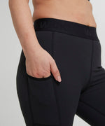 Wuka performance leggings in black showing the elasticated waist band and side pocket