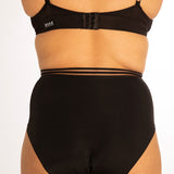 Close up of woman stood backwards on a white background wearing the WUKA re-purpose high waisted heavy flow period pants