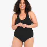 A woman wearing the WUKA Scoop Back Period Swimsuit - Light/Medium Flow. 